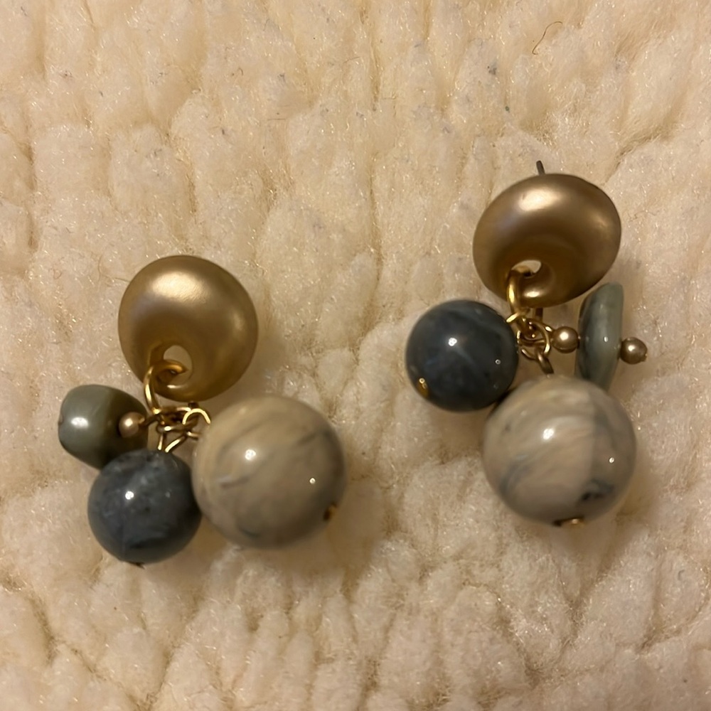 Cute and funky earrings with marble colored round beads and featuring a unique a